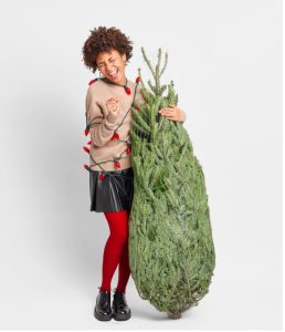 woman singing with christmas tree