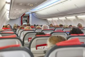Packed comercial airplane interior. Travel transportation and tourism industry
