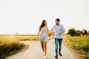 Couple walking on sunny field