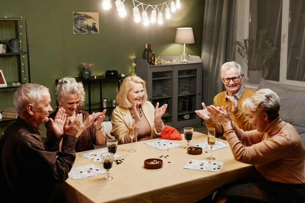 Several old people playing board game