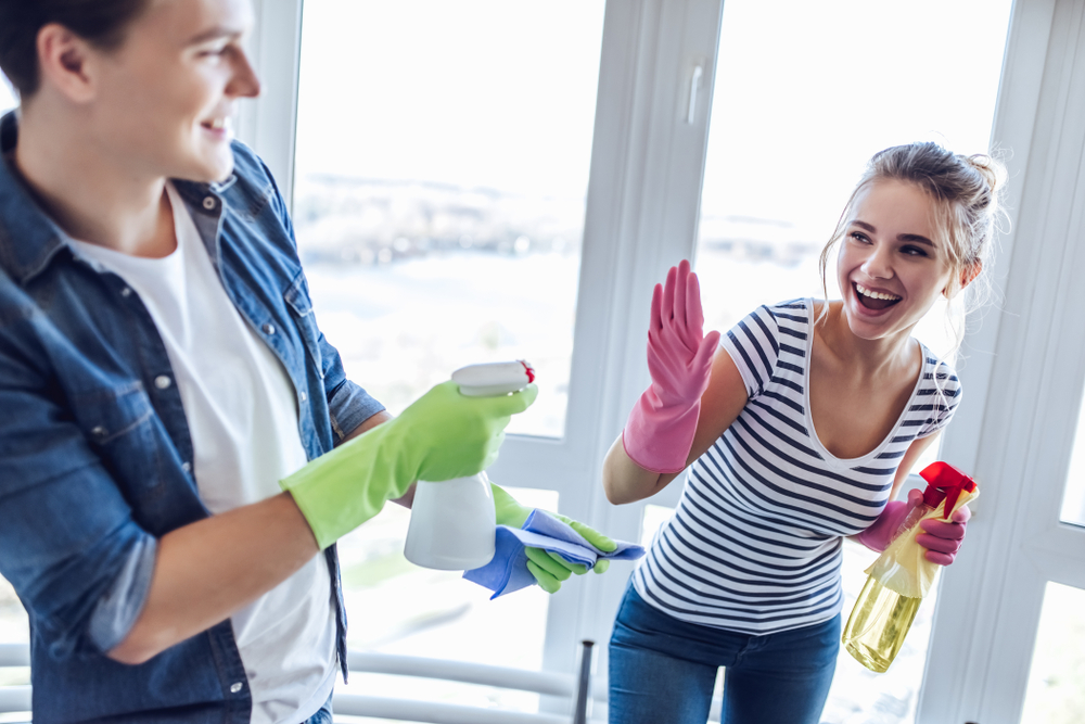 young,happy,couple,is,having,fun,while,doing,cleaning,at