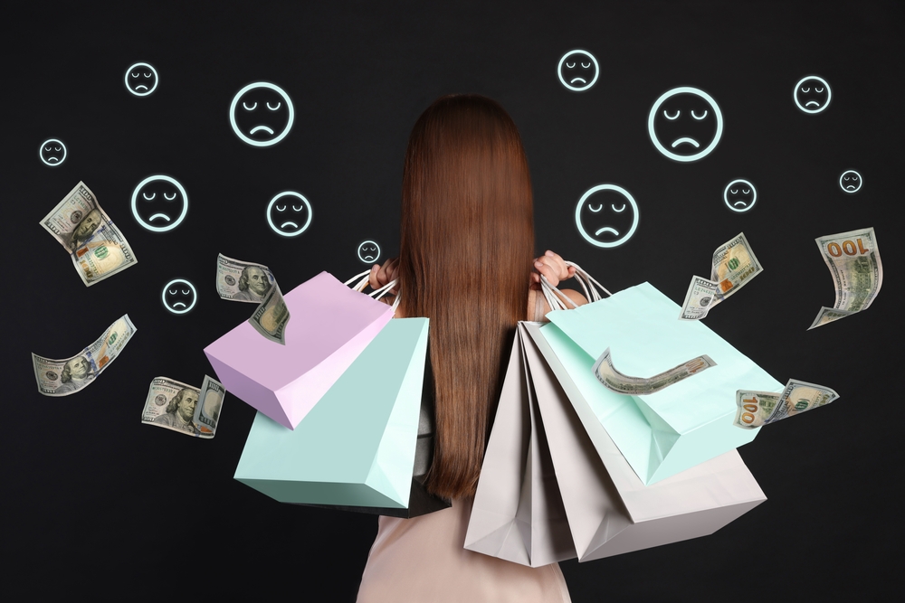 woman,with,shopping,bags,on,black,background,,back,view.,sad